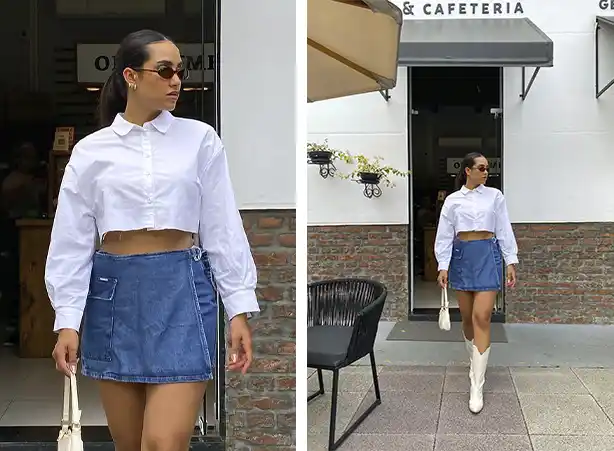 Look de camisa branca feminina cropped com short-saia jeans e bota branca cano alto