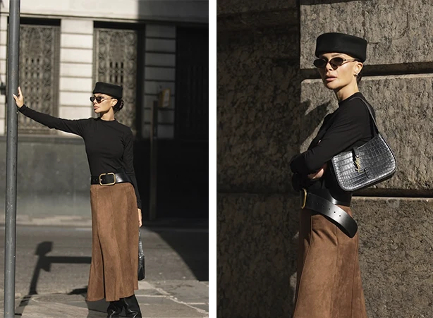 Look de outono com blusa preta e saia midi marrom